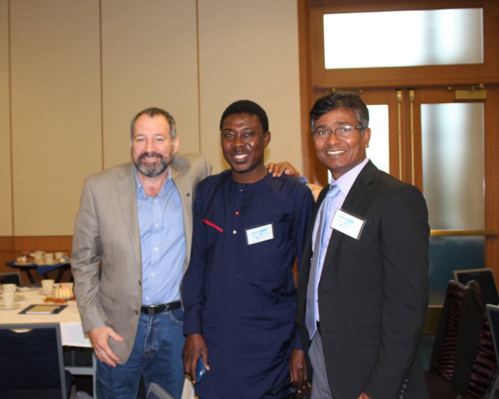 Image 1 of 15 Dr. Bawole, friend, and Dr. Molla standing together, smiling